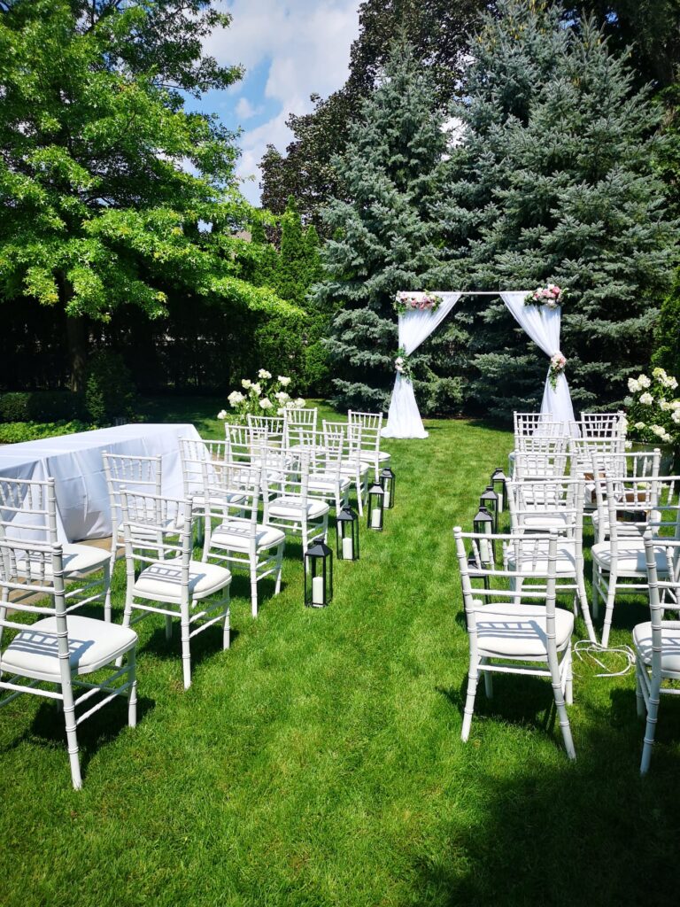 white-table-chair-greeneery-flower-arch-Toronto-Wedding-Rental-Flower-Arches